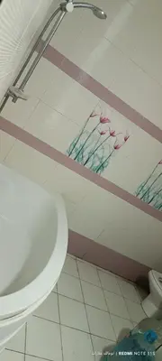 a bathroom with a white toilet and a mirror at شقة كورنيش النيل 3غرف فيو كامل علي النيل in Aswan