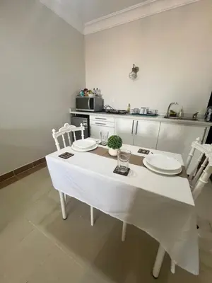 a kitchen with a white table with two plates on it at Studio sea view in Hurghada