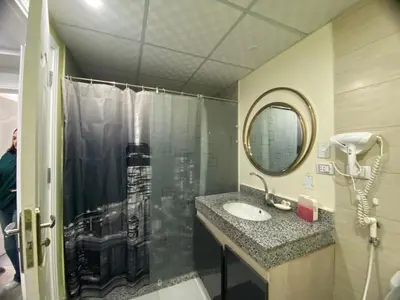 a bathroom with a shower and a sink and a mirror at Luxury serviced apartments in Hurghada