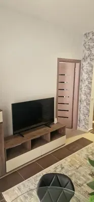 a living room with a flat screen tv on a entertainment center at Blue Dream in Hurghada
