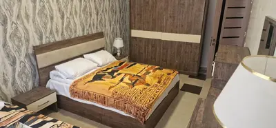 a bedroom with a bed with a blanket on it at Blue Dream in Hurghada