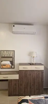 a room with a bed and a desk with a lamp at Blue Dream in Hurghada