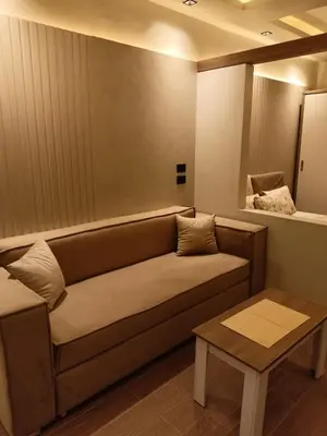 a living room with a couch and a table at Palma House in Hurghada