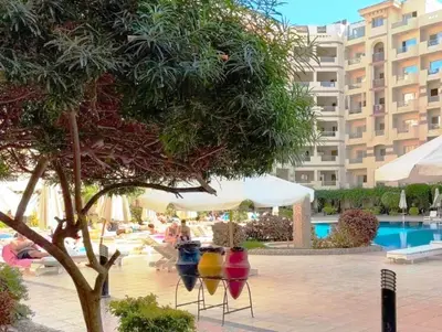 a resort with a pool and a large building at Florenza Khamsin, Studio i415-B in Hurghada