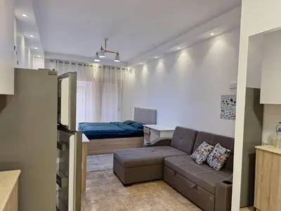 a living room with a couch and a bed at Florenza Khamsin, Studio i415-B in Hurghada