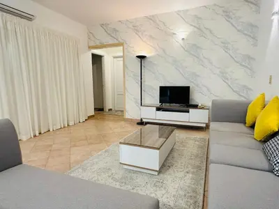 a living room with a couch and a tv at Enjoy a peaceful stay in Hurghada