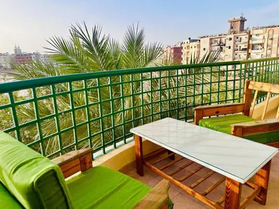 a balcony with a table and chairs on a balcony at Enjoy a peaceful stay in Hurghada