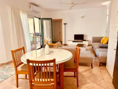 a living room with a table and chairs and a couch at Enjoy a peaceful stay in Hurghada