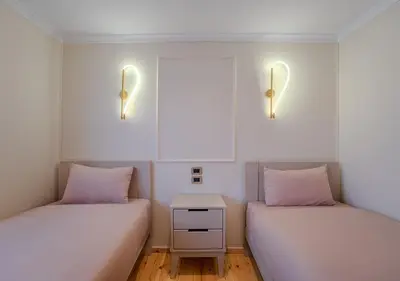 two beds in a small room with lights on the wall at Anoush Dahabiya 4 nights from Luxor to Aswan each Monday in Luxor