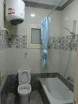 a bathroom with a toilet and a bath tub and a sink at Hurghada Apartment sea view Fiesta 209 in Hurghada