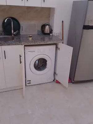 a kitchen with a washing machine and a sink at Hurghada Apartment sea view Fiesta 209 in Hurghada
