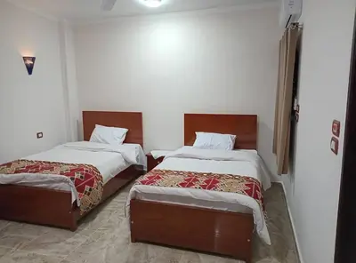 a room with two beds in a room at Maat Studio in Luxor