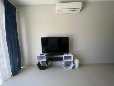a flat screen tv sitting on a stand in a room at Tawila 3BR Family Townhouse • Lagoon Retreat Villa in Hurghada