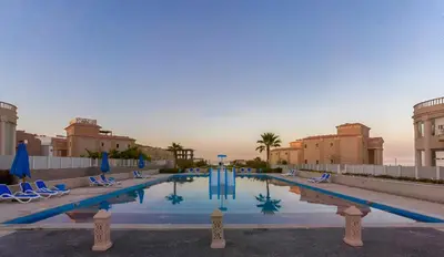 a swimming pool in a resort with chairs and buildings at Selena Bay Boutique Hotel in Hurghada