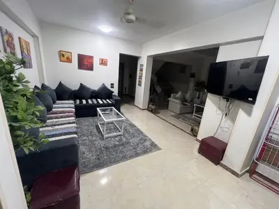 a living room with a couch and a flat screen tv at Mohamed Home in Jazīrat al ‘Awwāmīyah