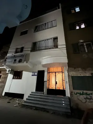 a building with a door and stairs in front at Mohamed Home in Jazīrat al ‘Awwāmīyah