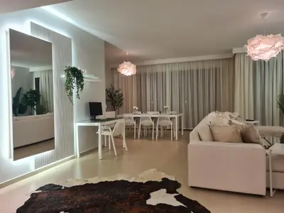 a living room with a white couch and a table at El Gouna - 3 Bedroom - Rooftop-Pool - Ancient Hills in Hurghada