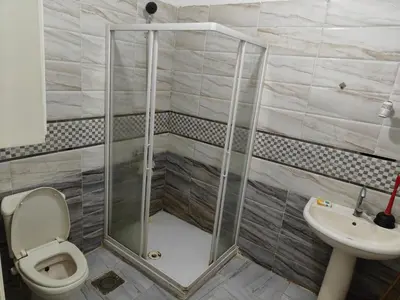 a shower in a bathroom with a toilet and a sink at Apartment in port Ghalib in Port Ghalib
