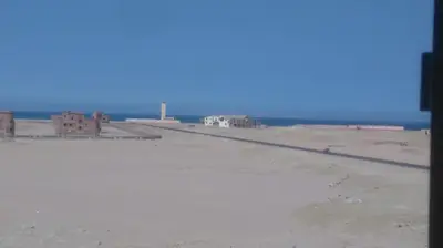 a view of a beach with buildings and the ocean at Sun and fun Hurgadah Apartments in Hurghada
