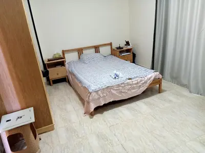 a bedroom with a bed and two night stands at Sun and fun Hurgadah Apartments in Hurghada