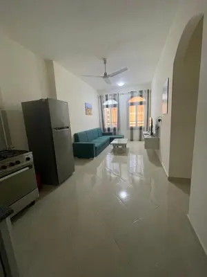 a large living room with a couch and a refrigerator at Bayt Hassan A7 - fabulous 2 bedrooms apartment in Hurghada