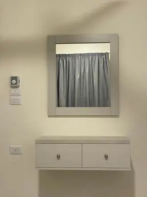 a mirror above a dresser in a room at Bayt Hassan A7 - fabulous 2 bedrooms apartment in Hurghada