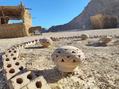 a group of pottery items on a desert field at Ocean Apartment in Hurghada