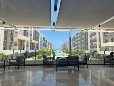 a patio with chairs and a table in a building at فنادير باي in Hurghada
