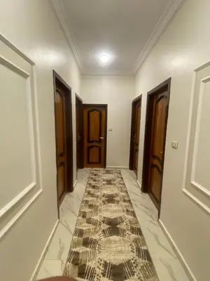 a hallway with doors and a tile floor at Garden view in Aswan