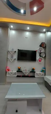 a living room with a flat screen tv on a wall at Sila in Hurghada