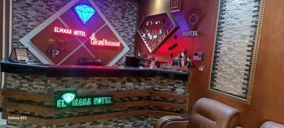 a bar in a restaurant with neon signs at El Massa in Idfu