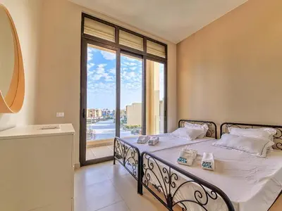 a bedroom with a bed with a large window at El Gouna Villa in Tawila with private pool in Hurghada