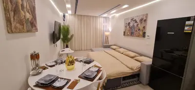 a room with a bed and a table in it at The dune Terrace in Hurghada