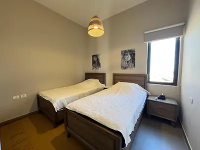 a bedroom with two twin beds and a window at Tawila Luxury 2BR Skyline Loft • Rooftop in Hurghada