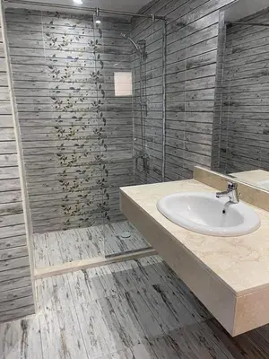 a bathroom with a sink and a shower at live in luxury hotel-style apartment in the heart of the city in Hurghada