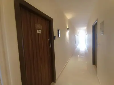 a hallway with a wooden door and a hallway with a light at 2 bed Flat, Hurghada, long&short in Hurghada