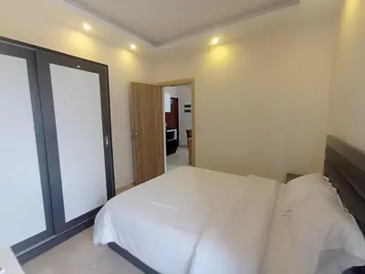 a bedroom with a white bed and a large window at 2 bed Flat, Hurghada, long&short in Hurghada