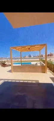a wooden bench sitting on top of a beach at Villa ancient hill in Hurghada