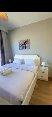 a bedroom with a large bed with white sheets and pillows at Villa ancient hill in Hurghada