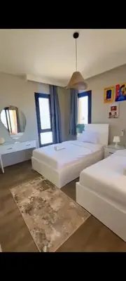 a large bedroom with two beds and a pendant light at Villa ancient hill in Hurghada