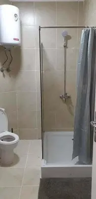 a bathroom with a shower and a toilet at Regency towers résidence in Hurghada