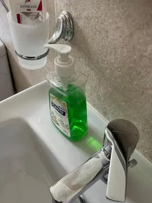 a bottle of mouthwash sitting on top of a sink at Bayt Hassan S18 - Fabulous Roof top 1 bedroom apartment in Hurghada