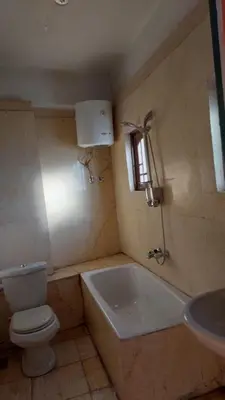 a bathroom with a toilet and a tub and a sink at Downtown apartment in Luxor