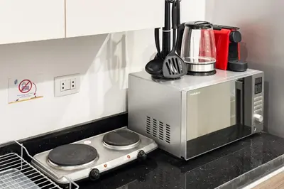 a microwave oven sitting on top of a kitchen counter at The Softline Studio G-Cribs in Hurghada
