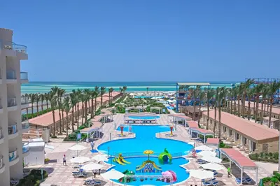an aerial view of a resort with a pool and the beach at Riviera Aqua Park Resort in Hurghada