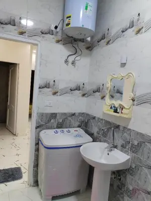 a bathroom with a sink and a toilet and a mirror at Dream House in Hurghada