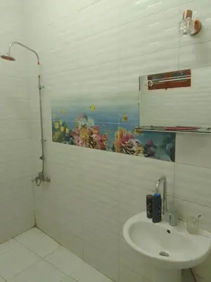 a bathroom with a sink and an aquarium on the wall at Neu Student Home 2 in Jazīrat Aswān