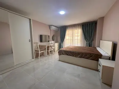 a bedroom with a bed and a table and a window at Apartment with private beach 09E in Hurghada