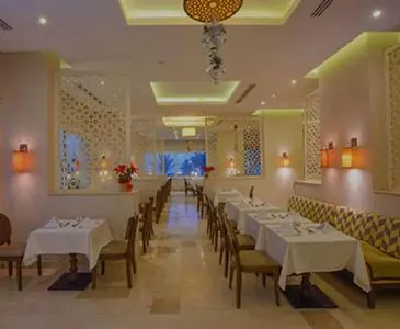 a dining room with tables and chairs in a restaurant at Salvatore Rooms All Inclusive -Cornich Street in Hurghada