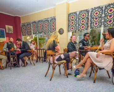 a group of people sitting in chairs in a room at Salvatore Rooms All Inclusive -Cornich Street in Hurghada